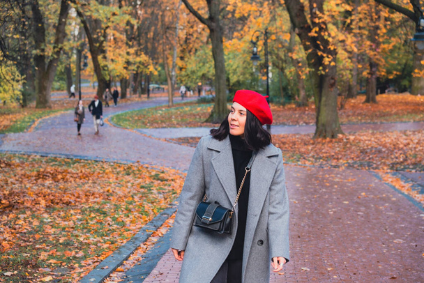 beautiful woman in autumn outfit at city public park copy space - Photo, Image