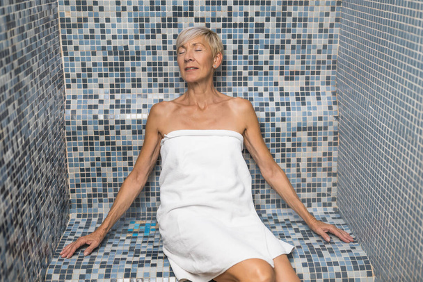 Mature woman is steam bath. Healthy lifestyle for elderly people. Spa concept. - Foto, immagini