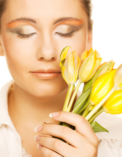 woman with yellow tulips  over white - Photo, image