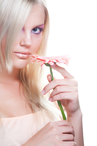 Beautiful young woman with gerber flower - 写真・画像