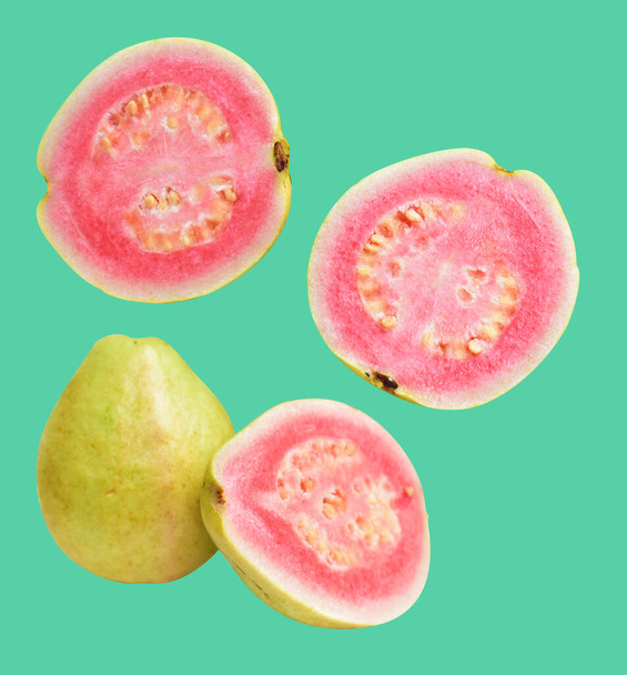 Pink or red Gauva fruit isolated with clipping path in green background, no shadow, healthy tropical fresh fruit - Photo, Image