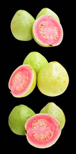 Pink or red Gauva fruit isolated with clipping path in black background, no shadow, healthy tropical fresh fruit - Photo, Image