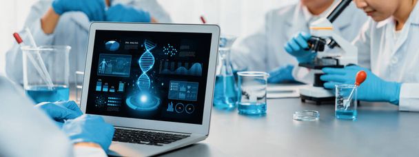 Dedicated scientist group working on advance biotechnology computer software to study or analyze DNA data after making scientific breakthrough from chemical experiment on medical laboratory. Neoteric - Photo, Image