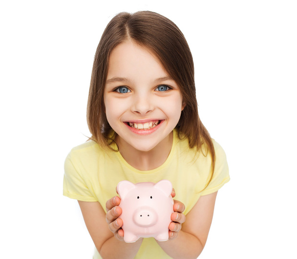 beautiful little girl with piggy bank - Foto, Imagen