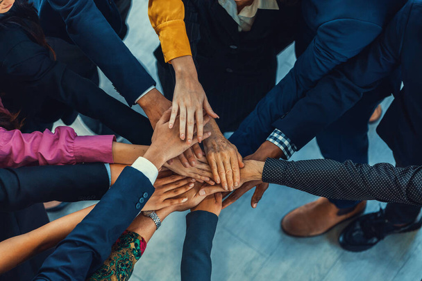 A group of diversity people putting their hands together. Showing unity teamwork and friendship. Close up top view of young business man and business woman joining as a team. Intellectual. - Photo, Image