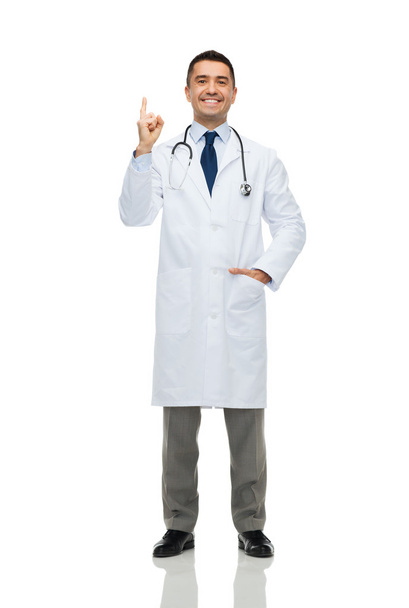 happy male doctor in white coat pointing finger up - 写真・画像