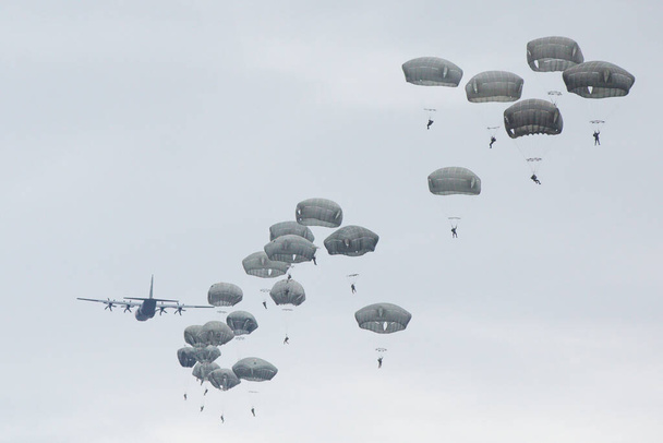 lots of parachutists in the cloudy sky - Photo, Image