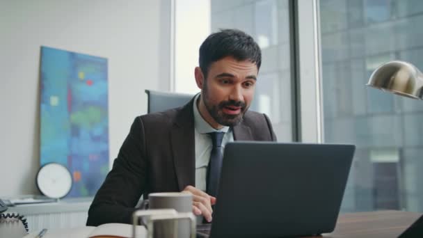 Satisfied businessman feeling success reading good news on laptop screen sitting office close up. Triumphing man worker rejoicing great result business profit. Happy bearded manager gesturing yes. - Footage, Video
