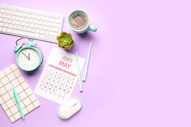 Composition with calendar, alarm clock, cup of coffee and keyboard on lilac background - Photo, Image