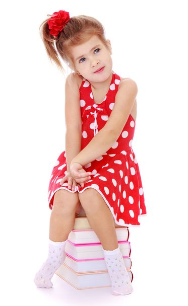 little girl in a red dress with white polka dots stands next to - Fotoğraf, Görsel