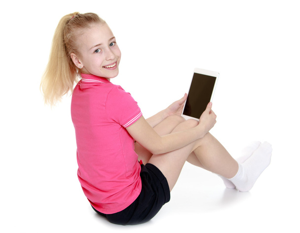 Girl sitting with a tablet PC or e-book - Fotó, kép