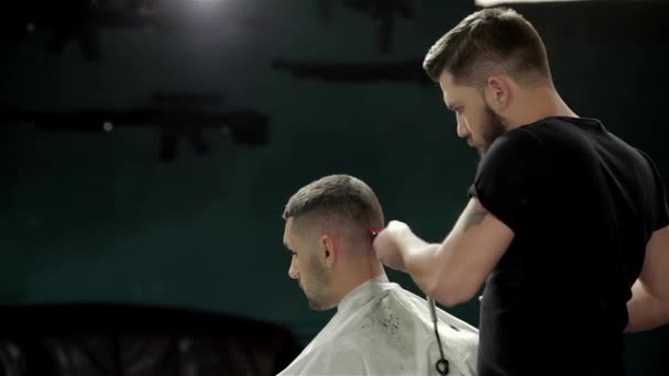 Mens hairstyling and haircutting in a barber shop or hair salon. Grooming the beard. Barbershop. Man hairdresser doing haircut beard adult men in the mens hair salon. Hairdressers in the workplace - Footage, Video