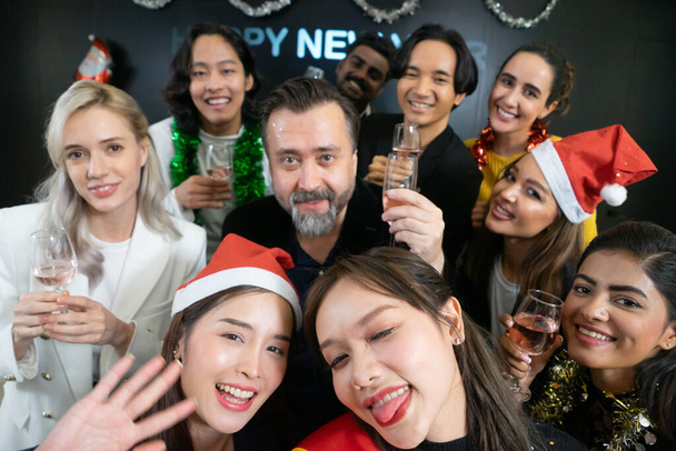 Let's take a selfie !! A group of diverse business people and colleagues having fun together at a business New Year party. A teamwork celebration of a successful. - Photo, Image