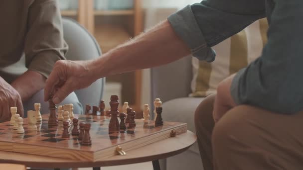Cropped slowmo of two unrecognizable opponent men shaking hands after end of chess game indoors - Footage, Video