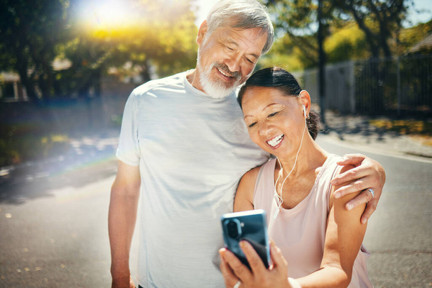 Couple, smile and break from run for social media, meme and funny joke in street, humor and comedy. Happy senior people, retirement and fitness for health, laughing and earphones for smartphone. - Foto, imagen