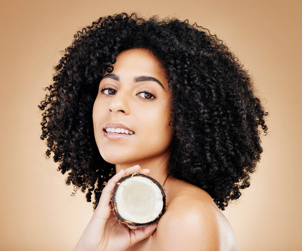 Studio woman, beauty portrait and coconut skin detox, vegan nutrients or organic facial cosmetics, antioxidants or self care. Clean face, fruit benefits and model skincare product on brown background. - Photo, Image