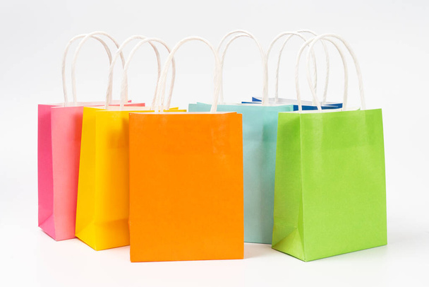 multi colored gift or shopping bags in row isolated on white background, for sales and promotion event. - Photo, Image
