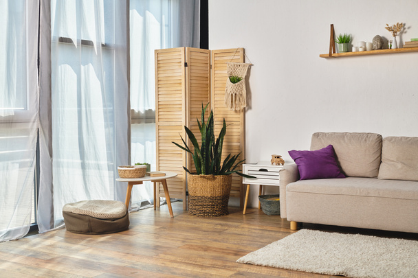apartman, tágas nappalival, modern bútorokkal, nagy ablakokkal és zöld cserepes növényekkel - Fotó, kép