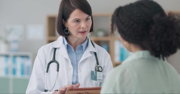 Doctor, woman and tablet in healthcare consultation, hospital support and feedback or online results. Medical professional talking to patient of digital report, charts or technology for clinic advice. - Footage, Video
