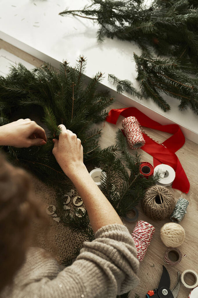 High angle view of unrecognizable woman making a Christmas wreath  - Photo, Image