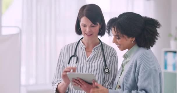 Tablet, conversation and doctor with woman in office of hospital for diagnosis or treatment research. Digital technology, healthcare and medical worker talk to patient at consultation in clinic - Footage, Video