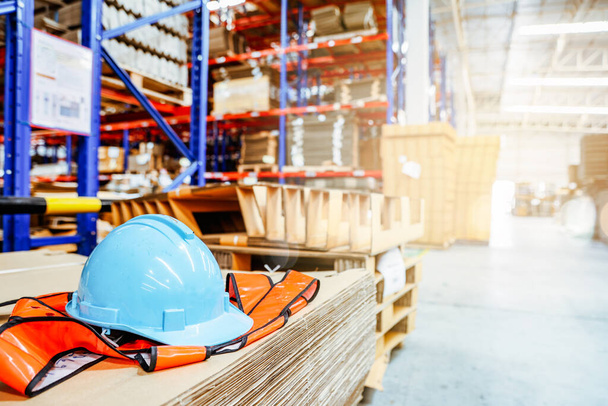 Working safely and protecting yourself from accidents safety helmet : Hardhats are placed in the workplace inside the warehouse production and export factory modern logistics with secure systems. - Photo, Image