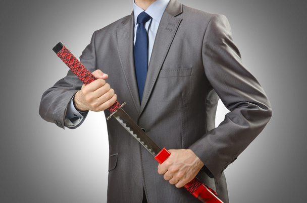Businessman with sword against the gradient - Foto, afbeelding