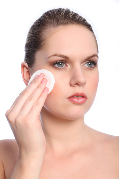 Beautiful girl using cosmetics cotton pad on face - Фото, зображення