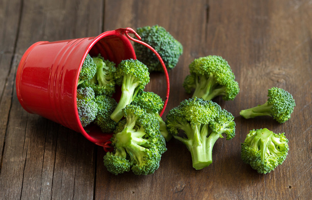 Green broccoli in red bucket - Photo, Image