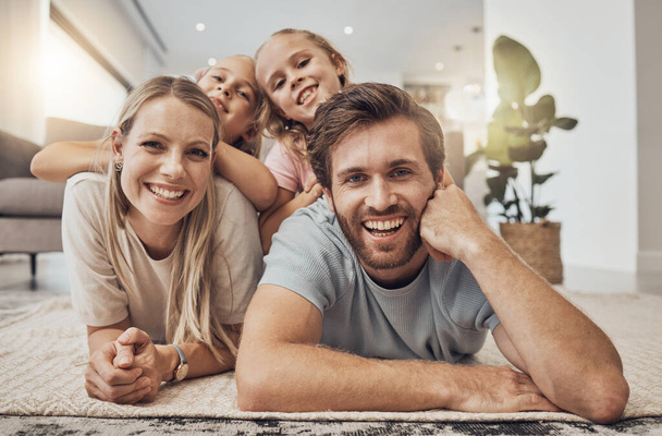 Home, portrait and family with girls on the floor, relax and happiness with joy, cheerful and weekend break. Children, mother or father with kids on the ground, calm or care with a smile in a lounge. - Photo, Image
