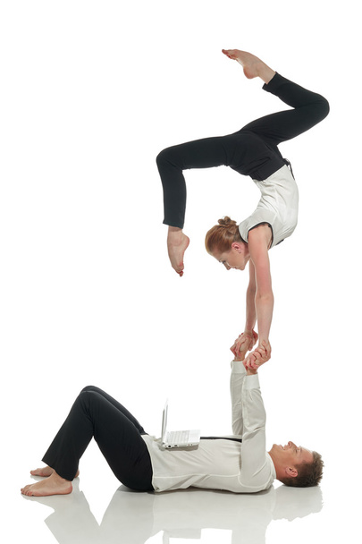 Acrobatic business people doing handstand in pair - Foto, imagen