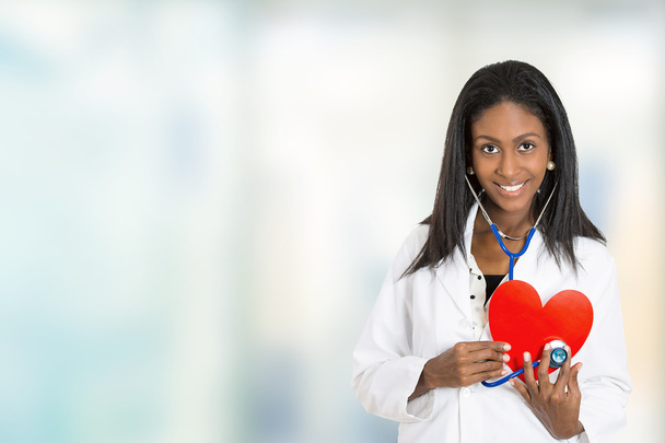 confident female doctor medical professional holding red heart - Zdjęcie, obraz