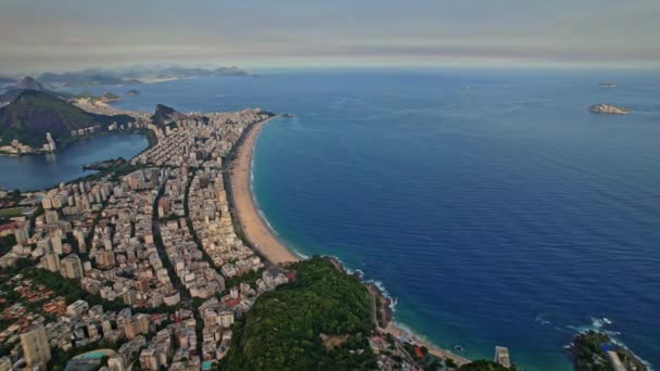 Drone Footage of the Mountains Dois Irmaos located in Rio De Janeiro in Brazil. The footage start with dolly backward movement to see the sea and city and later the mountains Dois Irmaos. - Footage, Video