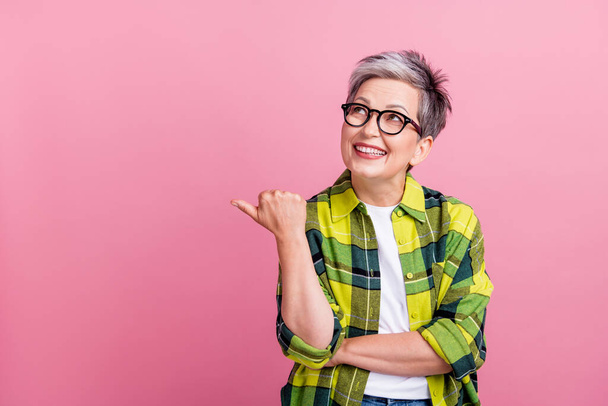 Portrait of nice person with white gray hair dressed plaid shirt look directing at offer empty space isolated on pink color background. - Valokuva, kuva