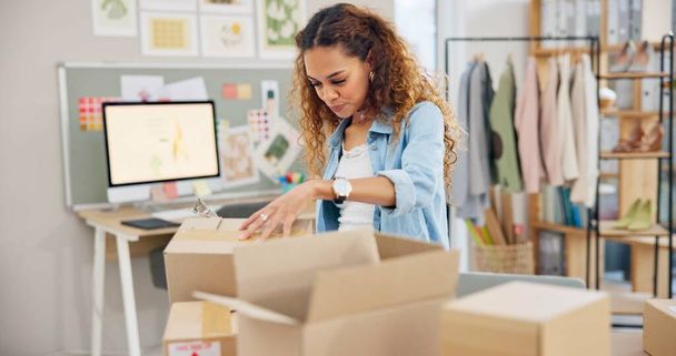 Online order, label check and woman with small business in fashion with delivery and cardboard box. Stock, startup and sales of ecommerce and web boutique at home of a entrepreneur with checklist. - Photo, Image