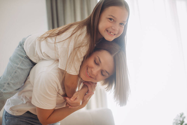 Enjoying in every moment with your kid. Mother and daughter at home - Photo, Image