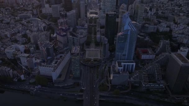 High angle view of busy trunk road and bridge over Seine River. Tilt up reveal of skyscrapers in modern La Defense district at dusk. Paris, France. - Footage, Video