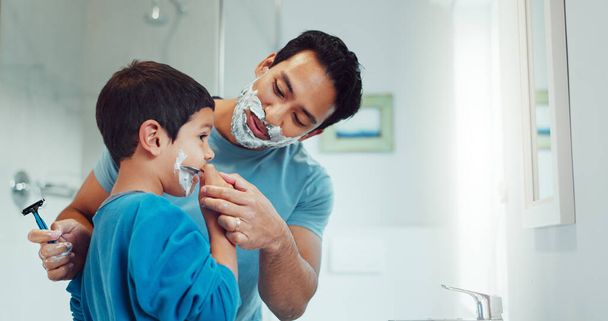 Shaving cream, child and father teaching in bathroom, family home or boy learning morning skincare, beauty and grooming routine. Shave together, son and dad helping with foam, razor and skin care. - Photo, Image