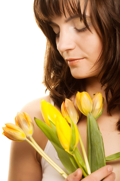 picture of happy woman with yellow tulips  over white - Foto, afbeelding
