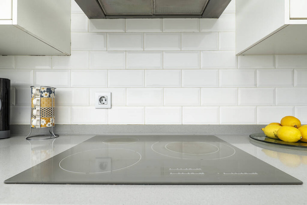 a ceramic hob integrated into the gray stone countertop - Photo, Image