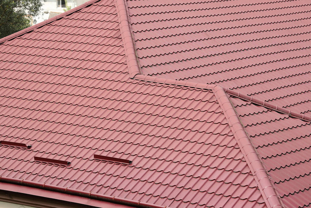 Decorative metal roof tiles in shape of old shingles. Type of roof of the house from a metal profile close up - Photo, Image