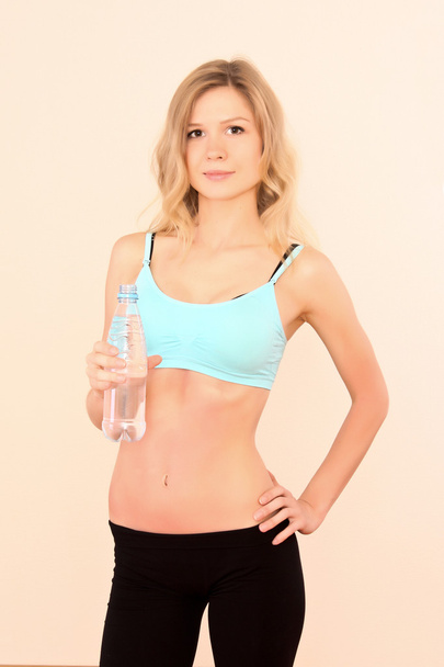 Young woman with bottle of water - Foto, imagen