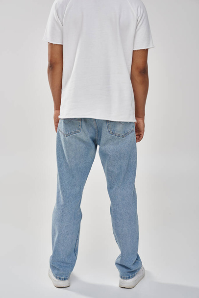 stylish african american man in trendy casual jeans and white t-shirt, copy space for advertising - Foto, immagini