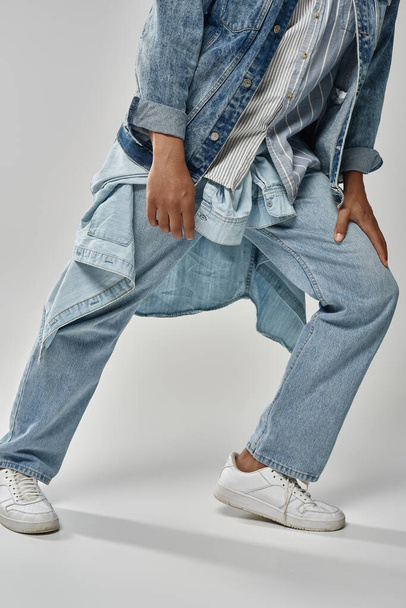 обрезанный вид на стильный африканский американский мужчина модель позирует в модном джинсовом наряде, концепция моды - Фото, изображение