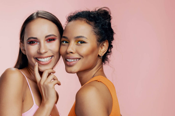 Portrait woman eye race together model pink two beautiful make-up attractive mixed caucasian colorful american healthy beauty skin bodycare studio care african girls face happy shine - Photo, Image