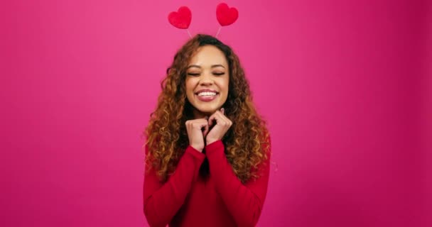 Cute young woman poses with hands under chin, dressed up for Valentines Day. High quality 4k footage - Footage, Video