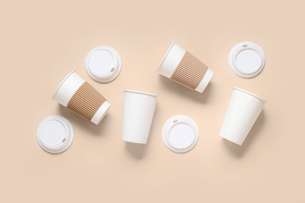 Takeaway paper cups with lids on beige background - Photo, Image