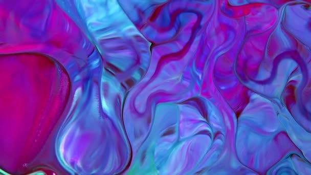 This stock video shows what happens when milk is introduced to a mixed-color paint. The colors swirl and form new shades of paint slowly flowing into a marbled mix. Use this abstract background by adding text and graphics, - Footage, Video