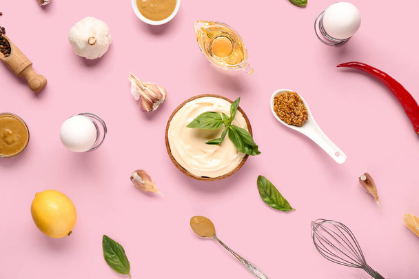 Bowl of fresh mayonnaise and ingredients on pink background - Photo, Image
