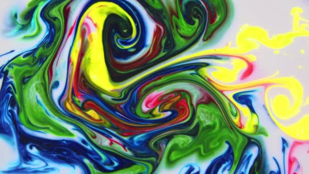 This stock video shows what happens when milk is introduced to a mixed-color paint. The colors swirl and form new shades of paint slowly flowing into a marbled mix. Use this abstract background by adding text and graphics, - Footage, Video